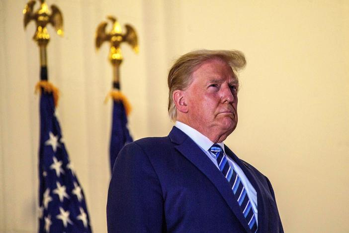 President Trump looks out from the White House on Monday after his release from Walter Reed National Military Medical Center.