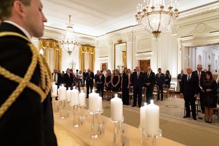President Donald Trump and First Lady Melania Trump join guests in singing "America the Beautiful" during a reception in honor of Gold Star Families on Sept. 27, in the East Room of the White House.
