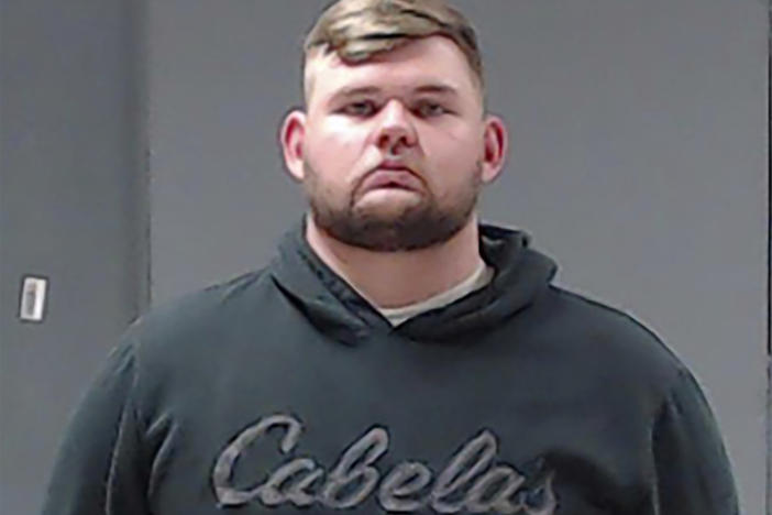 Former Wolfe City, Texas, police Officer Shaun Lucas, shown here in a booking photo, has been charged with murder in the fatal shooting of a Black man at a convenience store.