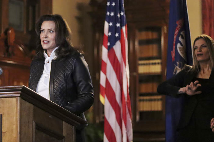 Michigan Gov. Gretchen Whitmer addresses the state during a speech Thursday in Lansing. Thirteen members of two militia groups face criminal charges after allegedly plotting to kidnap Whitmer.