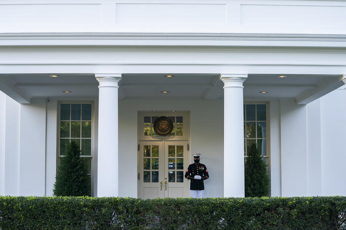 A Marine is posted Thursday outside the West Wing of the White House, signifying the president is in the Oval Office. President Trump's physician said that he could return to public engagements as soon as Saturday.