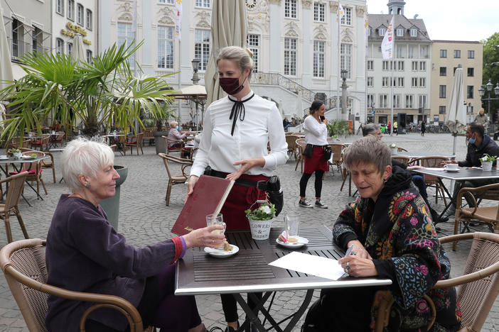 Outdoor dining in Bonn, Germany. Indoor dining is riskier than outdoor meals, experts say. Outdoor air can disrupt viral particles that have been expelled.