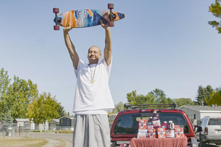 Nathan Apodaca's TikTok video, in which he longboards to Fleetwood Mac's "Dreams," has catapulted him to viral fame. Here, he is standing in the pickup truck given to him by Ocean Spray. In his video, Apodaca sips from a bottle of Ocean Spray's Cran-Raspberry juice.