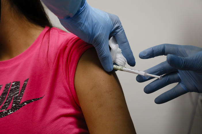 A volunteer received an injection as part of a clinical trial for a COVID-19 vaccine at Research Centers of America in Hollywood, Fla. Studies of vaccines backed by Operation Warp Speed have enrolled tens of thousands of people in a matter of months.