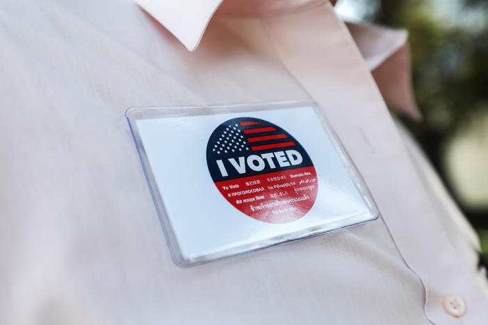 A voter wears an "I Voted" badge after placing a ballot in a drop box in Los Angeles last week. Officials say members of the Republican Party have illegally placed unauthorized drop boxes in some locations.