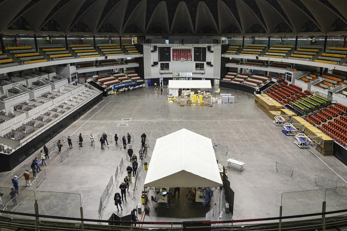 People queue to be tested for the coronavirus in a sports arena on Tuesday in Lyon, France. The World Health Organization said there were more than 700,000 new coronavirus cases reported in Europe last week.