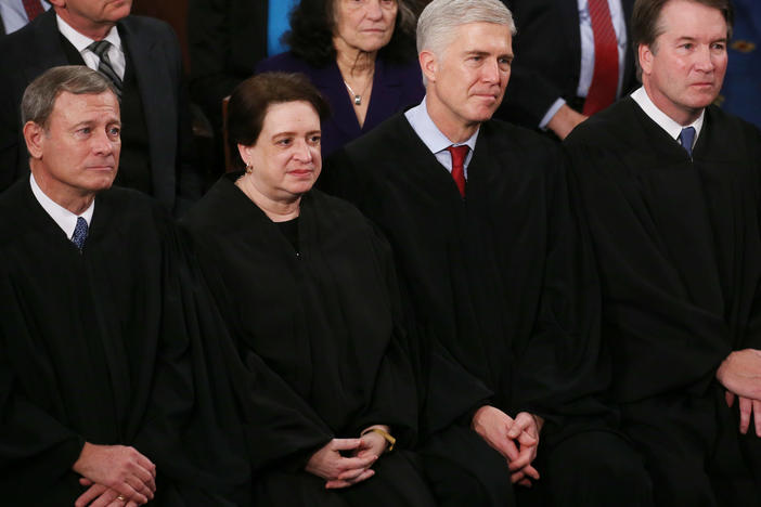 Supreme Court Justices (from left) John Roberts, Elena Kagan, Neil Gorsuch and Brett Kavanaugh attend the State of the Union address on Feb. 4, 2020. In her confirmation hearing, Judge Amy Coney Barrett explained the tradition of judges wearing black robes.