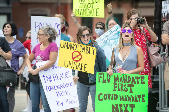 Anti-vaccine activists protested at the Massachusetts State House in August against Governor Charlie Baker's mandate that all students enrolled in child care, pre-school, K-12, and post-secondary institutions must receive the flu vaccine this year.