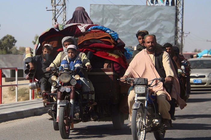 Afghans flee to Lashkar Gah, Helmand's provincial capital, during fighting between Taliban and Afghan security forces on Monday. Local authorities estimate that some 35,000 people have been displaced into Lashkar Gah since a Taliban offensive began in Helmand.