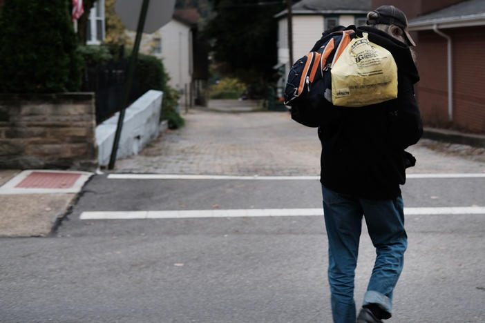 A homeless man walks downtown in East Liverpool, Ohio. Efforts to register homeless voters in the state have relied on churches and shelters volunteering to receive mail-in ballots for people with no permanent address.