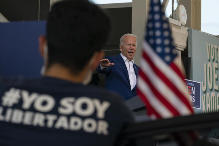 Democratic presidential nominee and former Vice President Joe Biden speaks at Miramar Regional Park in Miramar, Fla., on Tuesday, as supporters watch from their cars.