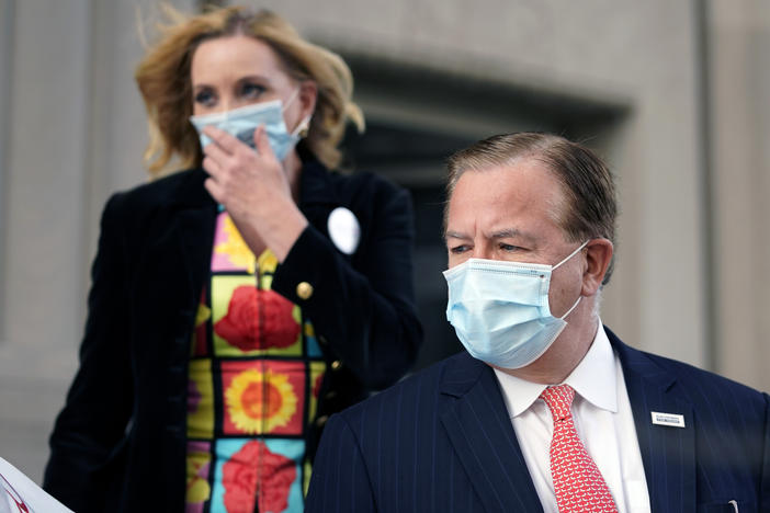 Mark and Patricia McCloskey leave a court hearing Wednesday in St. Louis. The McCloskeys pleaded not guilty to unlawful use of a weapon and tampering with evidence.