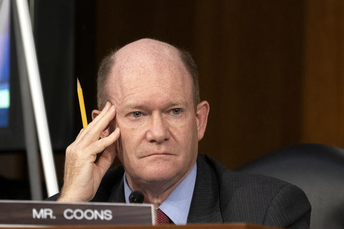 Sen. Chris Coons, D-Del., looks on as Supreme Court nominee Judge Amy Coney Barrett testifies before the Senate Judiciary Committee on the third day of her confirmation hearings.