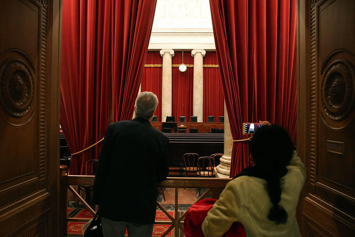 Tourists look into the chamber of the U.S. Supreme Court in February 2016.