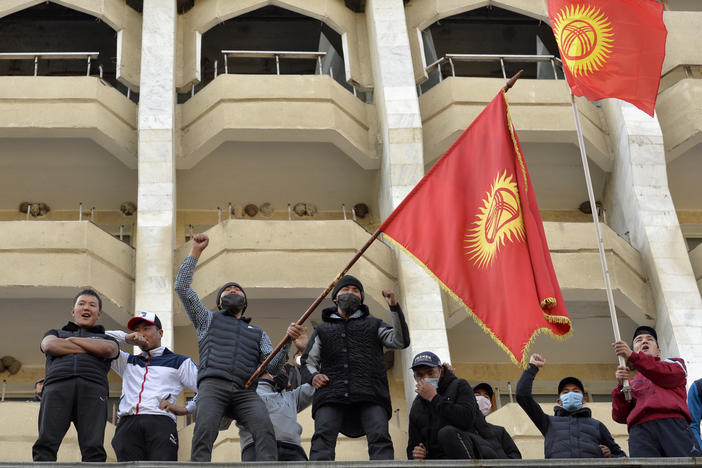 Supporters of Kyrgyzstan's Prime Minister Sadyr Japarov attend a rally in Bishkek, Kyrgyzstan, on Thursday. President Sooronbai Jeenbekov announced his resignation in a bid to end the turmoil that has engulfed the Central Asian nation after a disputed parliamentary election.