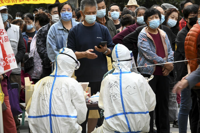 In this photo released by Xinhua News Agency, residents line up for COVID-19 tests in Qingdao this week. China says it has carried out 10 million tests in the northern port city, with no new cases found.