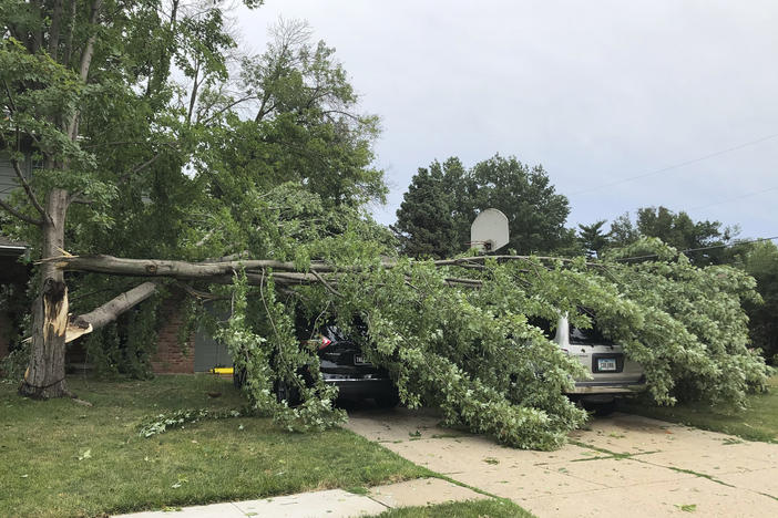 A tree fell across vehicles at a home in West Des Moines after a severe thunderstorm moved across Iowa on Aug. 10. It was the costliest storm system in modern U.S. history.