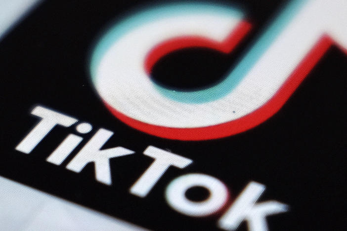 TikTok says it is banning all accounts that share content related to the QAnon conspiracy theory, hardening its previous policy on the far-right movement.