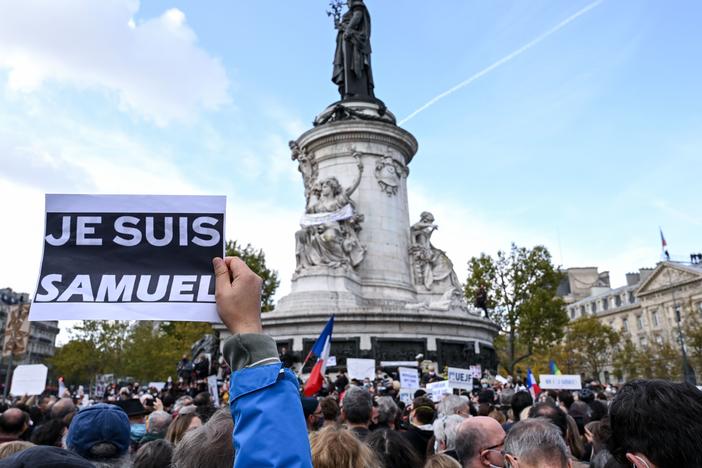 Demonstrators like the one shown here carried "I am Samuel" signs as they gathered on Place de la République in Paris on Sunday to pay tribute to slain history teacher Samuel Paty. Similar gatherings took place in several other cities as France reels from the attack.