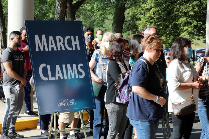 Hundreds of unemployed Kentucky residents wait in long lines outside the Kentucky Career Center in Frankfort for help with their unemployment claims on June 19. New research shows savings built up by the jobless are starting to run out.