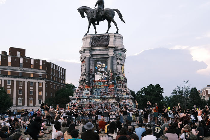 The Robert E. Lee statue on Richmond's Monument Avenue is seen here during a violin vigil to remember Elijah McClain in July.