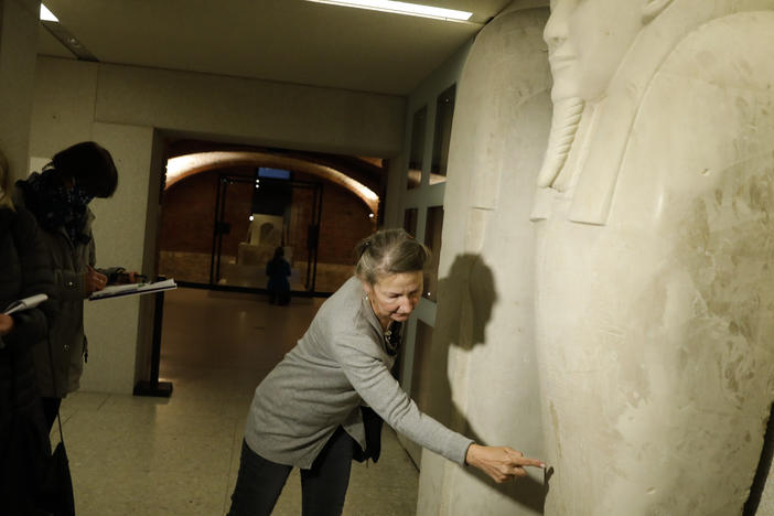 Friederike Seyfried, director of Antique Egyptian Department of the Neues Museum in Berlin, shows media a stain from liquid on the Sarcophagus of the prophet Ahmose on Wednesday.