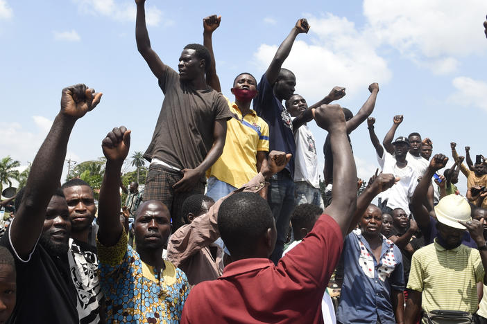 Protesters chant and sing solidarity songs as they barricade barricade the Lagos-Ibadan expressway on Wednesday to protest against police brutality and the killing of protesters by the military, at Magboro, Ogun State, Nigeria.