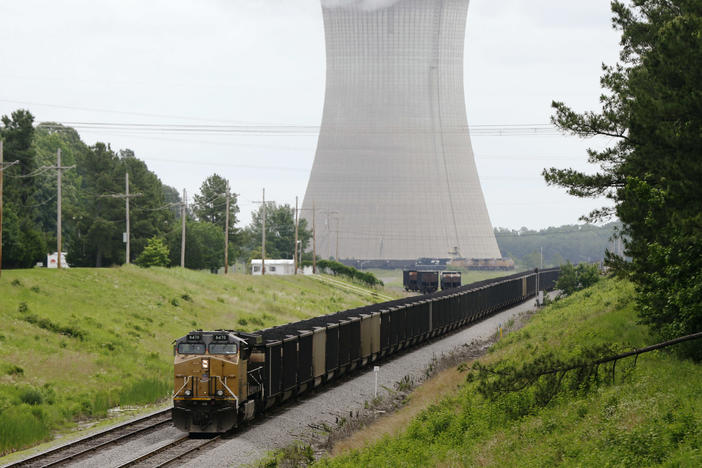 A coal train stops near the White Bluff Plant near Redfield, Ark. in 2014. Entergy Arkansas agreed to eventually stop using coal at this and another plant under a settlement with environmental groups, but a dark money nonprofit funded by Wyoming is pushing to keep them operating.