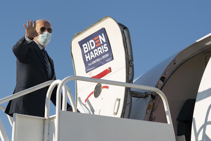 Democratic presidential nominee Joe Biden boards his campaign plane.