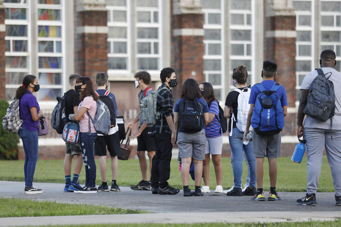 Students at Hillsborough High School in Tampa, Fla., wait in line to have their temperatures checked on Aug. 31. According to an updated tracker, Florida is one of three states that will offer full-time, in-person learning to more than 75% of students by Election Day.