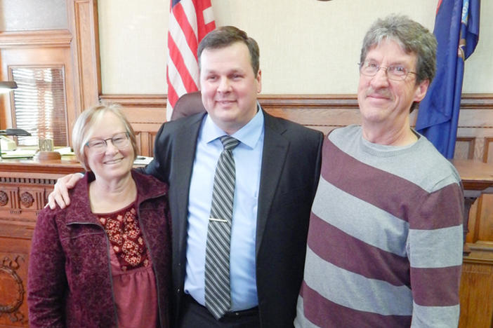 Left photo: Becky McKenney, left, and Mike McKenney, right, visit Bob VanSumeren while he was incarcerated. The couple are parents to Bob's former girlfriend, Jillian, who has also remained close to Bob. Right photo: Becky, Bob and Mike on the day that Bob was sworn in as an attorney.