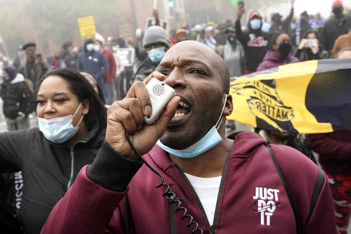 Rayon Edwards rallies protesters during a march Thursday for Marcellis Stinnette, who was killed by police in Waukegan, Ill.