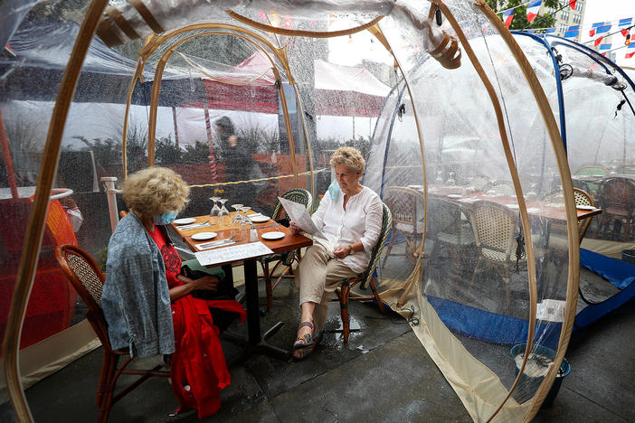 The latest pandemic dining twist is the outdoor bubble, seen here at a New York City restaurant. Sure, it's a way to stay warm as winter looms ... but does it reduce your risk of getting infected by COVID-19?