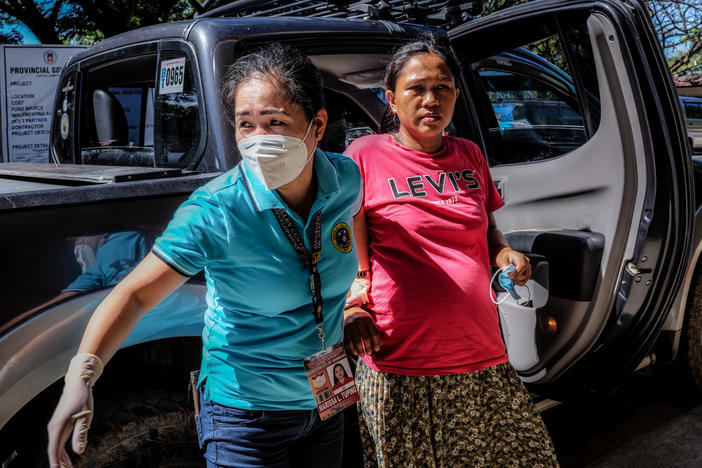 Marissa Tuping, a rural midwife, and Risa Calibuso, right, arrive in Nueva Vizcaya Provincial Hospital on July 21. Calibuso gave birth to her son moments later.