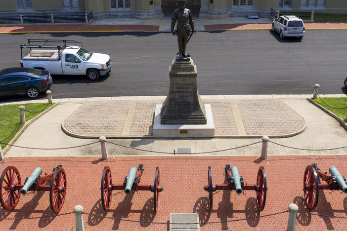 A statue of Confederate Gen. Thomas "Stonewall" Jackson stands behind cannons at the entrance to the barracks at Virginia Military Institute in Lexington, Va. Superintendent J.H. Binford Peay III resigned Monday amid allegations that the school's culture was hostile to Black cadets.