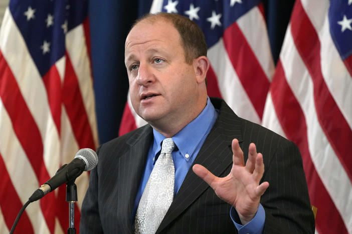 Colorado Gov. Jared Polis speaks during a news conference on Oct. 20 about the steady increase in new coronavirus cases in the state.