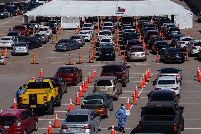 Cars line up Friday at a coronavirus testing site at the University of Texas at El Paso. The area has seen a surge in cases in recent weeks, and a two-week curfew is now in effect in El Paso County.