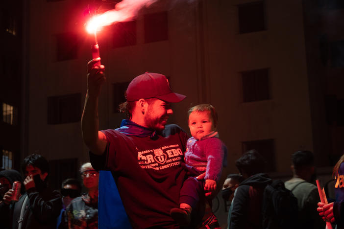 A family celebrates the approval of a new constitution in Santiago, Chile. After decades, the constitution from the country's years of dictatorship will finally be thrown out.