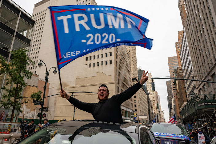 A person participates in a rally Sunday for President Trump on Fifth Avenue in New York City. Trump supporters and protesters clashed in Times Square, prompting nearly a dozen arrests.