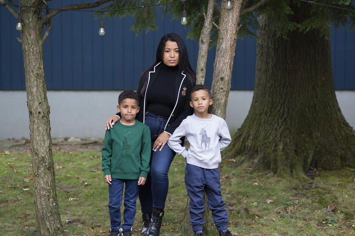 Farida Mercedes and her two sons Sebastian, 5, (left) and Lucas, 7, stand in their backyard in Fairlawn, N.J. Mercedes left her job as an assistant VP of HR at L'Oreal in August after working there for 17 years. As hundreds of thousands of women dropped out of the workforce in September, Latinas led the way, leaving at nearly three times the rate of white women.