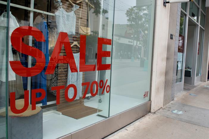 A store advertises discounts in Santa Monica, Calif., on July 28 amid the coronavirus pandemic. Economic growth data on Thursday are expected to show a record-setting figure for the third quarter, but that covers the more worrisome picture underneath the surface.