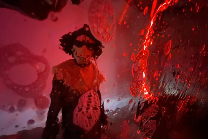 A menacing scarecrow approaches the driver's side as what looks like bloody bubbles slide down the window at a haunted car wash in Birmingham, Ala.