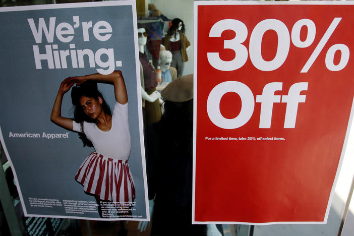 Signs in the window of a retail store offers discounts, and jobs, in Santa Monica, Calif. U.S. GDP grew at a record-setting rate, reflecting pent-up activity after the coronavirus lockdowns, but economists warn of trouble ahead.
