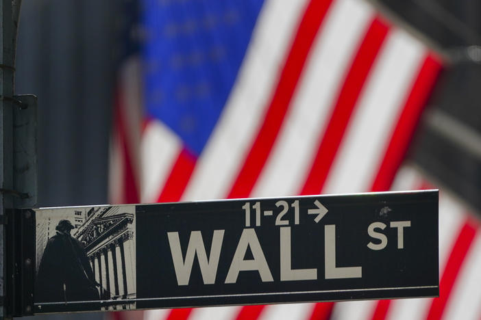 The U.S. flag hangs outside the New York Stock Exchange earlier this month. Investors have been grappling with a wave of uncertainty that's sent the market lower in recent weeks.