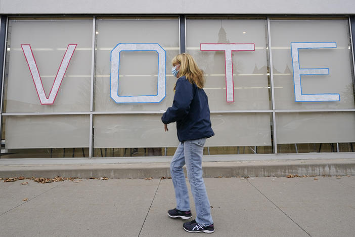 A local resident arrives to cast her ballot during early voting for the general election on Oct. 20 in Adel, Iowa. A new analysis by NPR, the Center for Public Integrity and Stateline reveals that since 2016, 261 polling places in the state have been closed, most due to COVID-19.