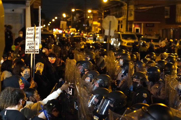 Protesters confront police during a march Tuesday in Philadelphia following this week's fatal police shooting of Walter Wallace Jr., a 27-year-old Black man.