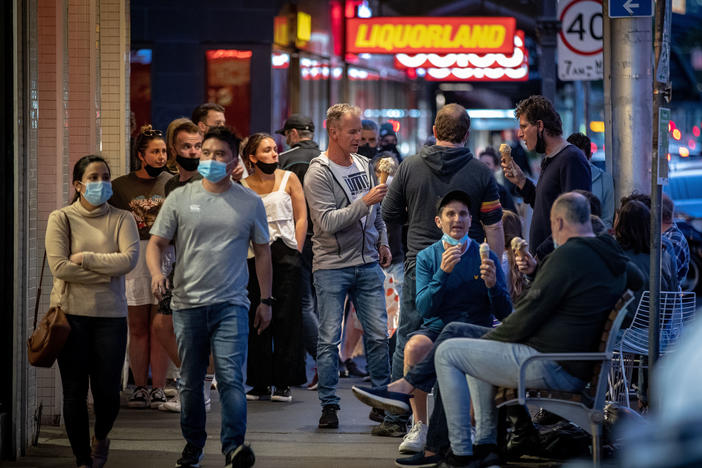 People enjoy eating outdoors on Wednesday in Melbourne, Australia. Lockdown restrictions in the city were lifted after 111 days, allowing people to leave their home for any reason.