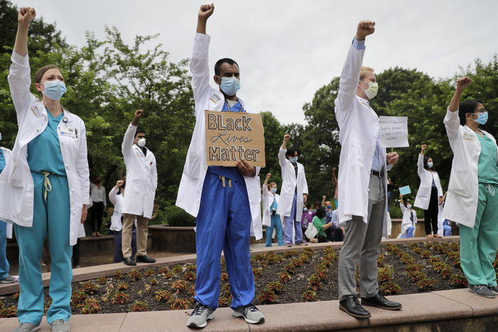 Health care professionals gather outside Barnes-Jewish Hospital in St. Louis in June to demonstrate in support of the Black Lives Matter movement.