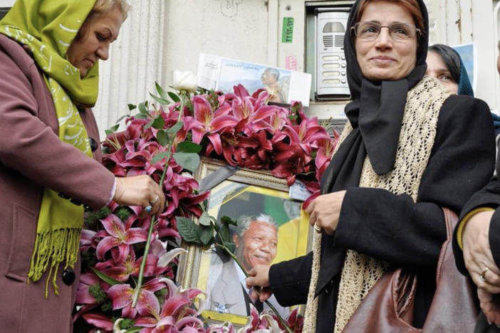 Iranian human rights lawyer Nasrin Sotoudeh with a poster of South Africa's Nelson Mandela, in a scene from the <em>Nasrin </em>documentary.