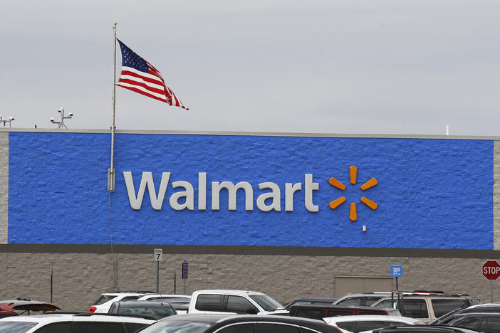 A U.S. flag waves over a Walmart parking lot in August in Oklahoma City. The company sells firearms in about half of its 4,700 stores in the United States.